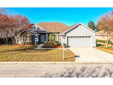 Single-story home with gray siding, stone accents, and a two-car garage at 6358 Alamanda Hills Dr, Lakeland, FL 33813