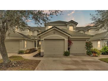 Two-story townhome with attached garage and landscaping at 649 Grasslands Village Cir, Lakeland, FL 33803