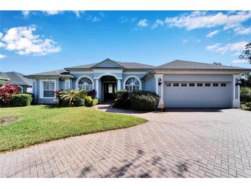 Gray two-story house with a three-car garage and landscaped yard at 7068 Island Lake Ln, Lakeland, FL 33813