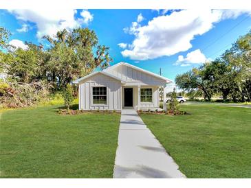 Newly constructed farmhouse-style home with a welcoming front porch at 825 S Seminole Ave, Fort Meade, FL 33841