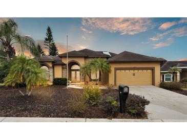 Single-story home with a two-car garage and landscaped yard at 6714 Highlands Creek Loop, Lakeland, FL 33813