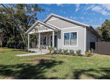 Charming single-story home with a welcoming front porch and well-manicured lawn at 127 W Belmar St, Lakeland, FL 33803