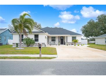 Beautiful two-story house with a landscaped yard and a long driveway at 1427 Magnolia Ln, Auburndale, FL 33823