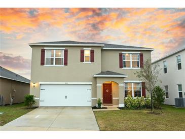 Two-story house with a two-car garage and landscaped lawn at 1726 Eagle Hammock Blvd, Eagle Lake, FL 33839