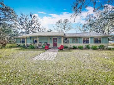 Ranch home with a brick facade and a covered porch at 2720 Ewell Rd, Lakeland, FL 33811