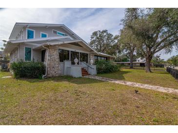 Charming two-story home with stone accents and a spacious lawn at 306 Avenue C Ne, Winter Haven, FL 33881