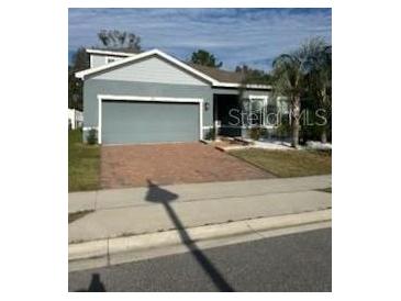 Single-story home with two-car garage and well-maintained lawn at 357 Siesta Vista Ct, Davenport, FL 33896