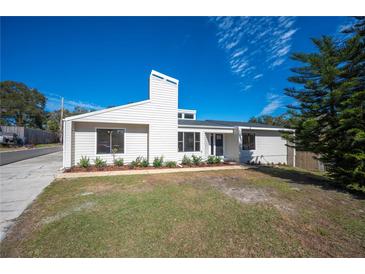 White single story home with landscaped lawn at 4718 Valley Hill Ct, Lakeland, FL 33813