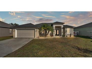 One-story home with attached garage and landscaped yard at 5181 Ashwood Dr, Lakeland, FL 33811