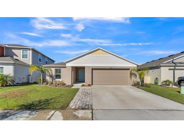 Single-story home with a two-car garage and landscaped lawn at 5440 Siltstone St, Lakeland, FL 33811