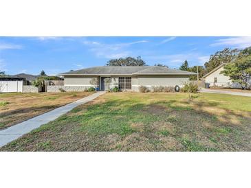 Single-story home with a well-maintained lawn and walkway at 6357 Neamathla Dr, Lakeland, FL 33813