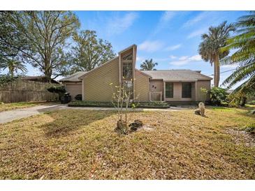 A charming one-story house with a unique angular design, situated on a grassy lot at 1005 Shadow Run Dr, Lakeland, FL 33813