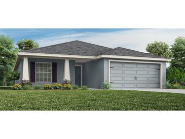 One-story home with gray siding, shutters, and a two-car garage at 1040 Aruba Ave, Mulberry, FL 33860