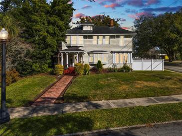 Two-story house with brick pathway, landscaped lawn, and charming porch at 2016 Seminole Trl, Lakeland, FL 33803