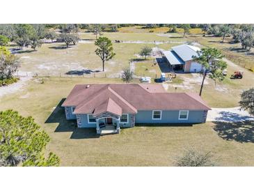 Aerial view of a ranch-style home with detached barn and expansive land at 2455 Gerber Dairy Rd, Winter Haven, FL 33880