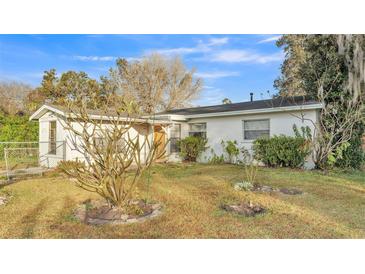 White single story house with a grassy lawn and mature trees at 470 Lucille St, Bartow, FL 33830