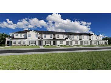 Modern townhome community with 5-unit building, grassy area, and street view at 5749 Freshwater Canyon Dr, St Cloud, FL 34771