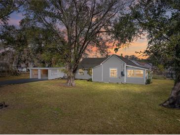 Charming house with a spacious yard, and carport at 702 Nw 1St Ave, Mulberry, FL 33860