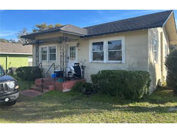 Tan house with a spacious yard and mature trees at 709 E Lowell St, Lakeland, FL 33805