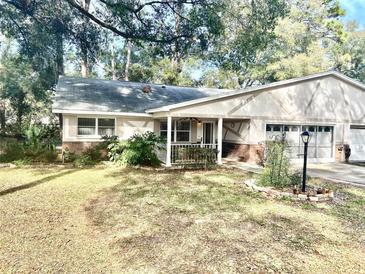 Charming single story home with a well-manicured lawn and mature trees at 8655 Sw 98Th Street Rd # A, Ocala, FL 34481