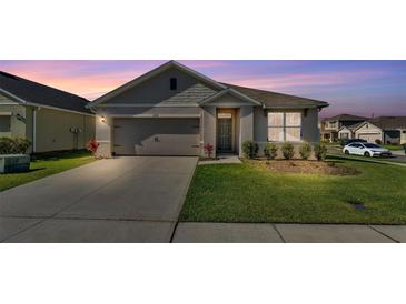 Charming single-Gathering home with a well-manicured lawn and an attached two-car garage at 1878 Pristine Loop, Lakeland, FL 33811