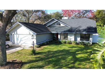 Single-Gathering home with a two-car garage and a well-manicured lawn at 4419 Burlington Dr, Winter Haven, FL 33880