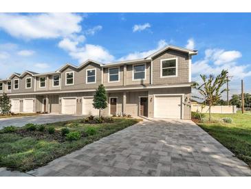 Three-unit townhome building with garage and landscaping at 460 N 1St Ave, Bartow, FL 33830