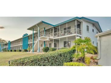 Two-story building with teal accents and screened balconies at 1600 W Lake Parker Dr # B9, Lakeland, FL 33805