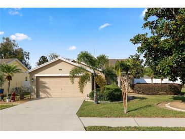 Charming single-story home featuring a well-manicured lawn and mature trees at 2160 Country Manor St, Bartow, FL 33830