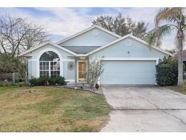 Charming single-story home with a well-maintained front yard and attached two-car garage, offering curb appeal at 403 Saint Anns Dr, Winter Haven, FL 33884