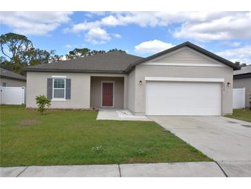 Charming single-story home with a well-maintained lawn and a two-car garage at 4932 St James St, Winter Haven, FL 33881