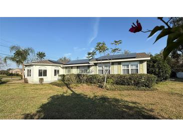 Charming home with a bay window, solar panels and well-maintained landscaping enhancing the curb appeal at 495 King St, Haines City, FL 33844