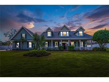 Charming two-story home featuring a large front porch and well-manicured lawn at 5155 Lake Deeson Woods Ct, Lakeland, FL 33805