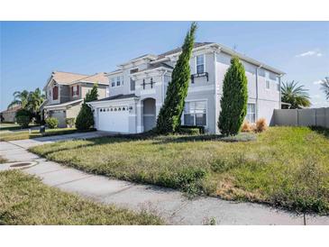 Two-story home featuring an attached two-car garage and low-maintenance landscaping at 6011 Placid Pass, Lakeland, FL 33805