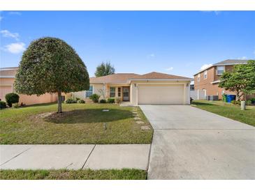 Charming single-Gathering home with a well-maintained front yard and two-car garage at 6610 Crescent Loop, Winter Haven, FL 33884