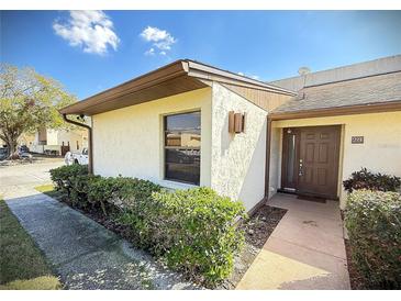 Charming home exterior featuring manicured greenery and a private walkway at 1880 N Crystal Lake Dr # 28, Lakeland, FL 33801