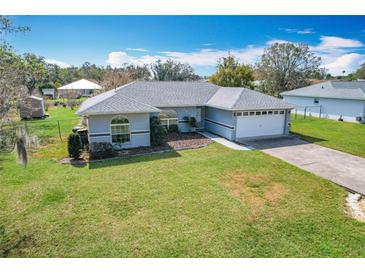 Charming single-story home with lush lawn, mature trees, and attached two car garage at 2532 Everleth Dr, Lakeland, FL 33810