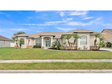 Charming single-story home featuring a well-manicured lawn, beautiful landscaping, and inviting curb appeal at 2917 Blackwater Creek Dr, Lakeland, FL 33810