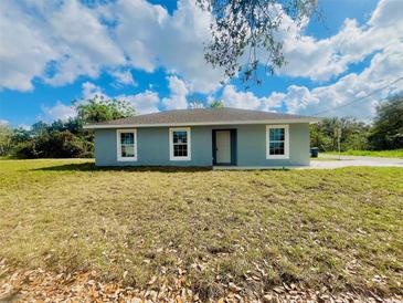 Charming single-story home with a well-maintained lawn under a beautiful cloudy blue sky at 3291 Alberta St, Bartow, FL 33830