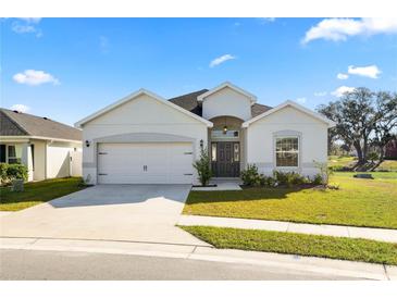 Charming single-story home with a well-manicured lawn, two-car garage, and inviting entrance at 3862 Willow Ridge Dr, Lakeland, FL 33810