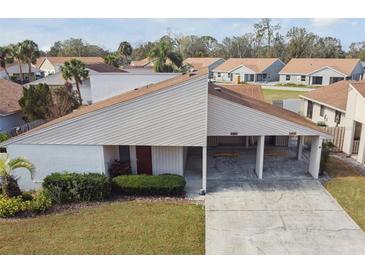 Charming one-story home featuring a covered parking area and well-maintained landscaping at 3901 Oak Loop # 33, Mulberry, FL 33860