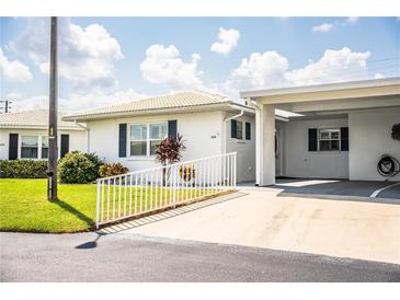 Charming single-story home with a well-maintained lawn and a covered carport at 474 Cameo Dr, Lakeland, FL 33803