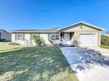 Charming single-story home with a well-manicured lawn and an attached one-car garage at 5121 Idlewood Ln, Lakeland, FL 33811