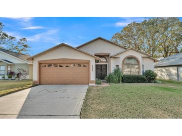 Charming single-story home with a well-maintained lawn, complemented by a two-car garage and neutral color scheme at 6224 Crane Dr, Lakeland, FL 33809