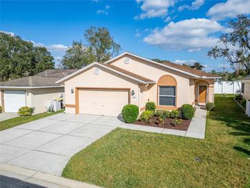 Charming single-story home featuring a well-manicured lawn and attached two-car garage at 6271 Res Cir, Lakeland, FL 33810