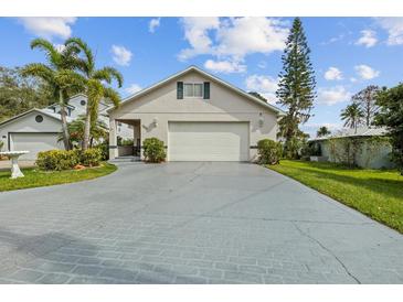 Charming home with landscaped yard, driveway, and attached two-car garage at 720 Lake Jessie Dr, Winter Haven, FL 33881