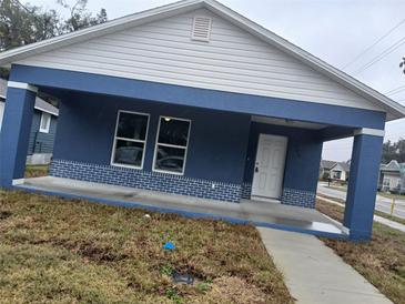 Charming single-story home with a blue painted exterior, white trim, and a covered front porch at 724 S 8Th St, Lakeland, FL 33805