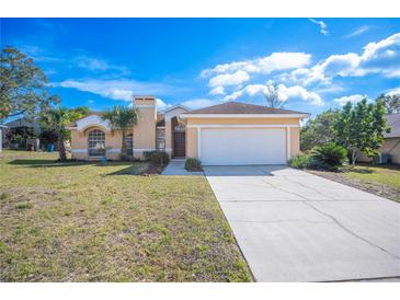 Charming single-story home features a two-car garage and well-maintained front yard at 736 Hunt Dr, Lake Wales, FL 33853