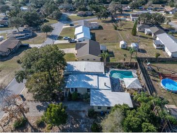 A cozy home featuring a backyard swimming pool and a privacy fence in a suburban neighborhood at 827 Sherwood Dr, Lake Wales, FL 33898