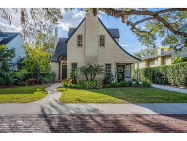 Charming home featuring a well-manicured lawn, lush landscaping, and a stone walkway leading to the entrance at 1819 Pawnee Trl, Lakeland, FL 33803